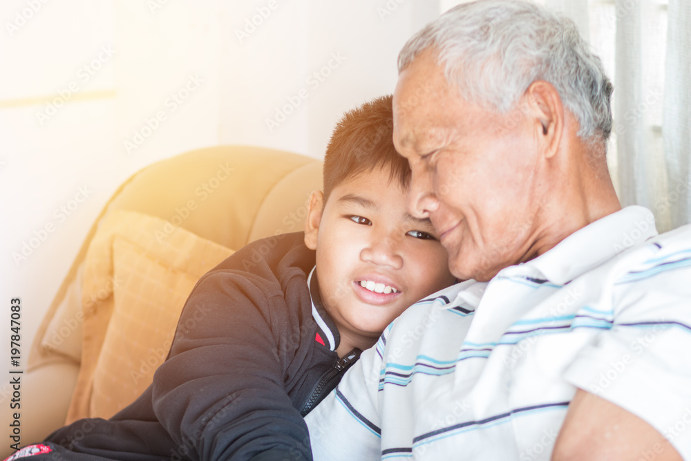Father and Dad Day concept : Asian retired Grandfather and nephew or grandson, young boy hugging Living in house happily together, relationship between familys members is guaranteed by warm family Father and Dad Day concept : Asian retired Grandfather and nephew or grandson, young boy hugging Living in house happily together, relationship between familys members is guaranteed by warm family