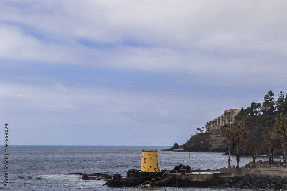 Atlantic Ocean coast in Funchal, the capital city of Madeira under the blue sky
