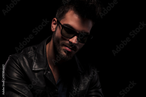 close up of fashion man with sunglasses smiling seductively