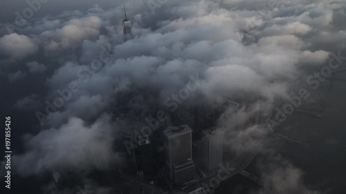 New York City aerial view of Lower Manhattan's Financial District from the East River, covered by low level clouds in the morning.