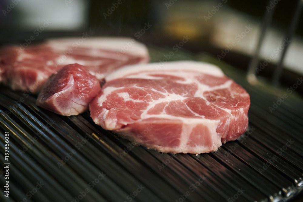 raw meat on grill