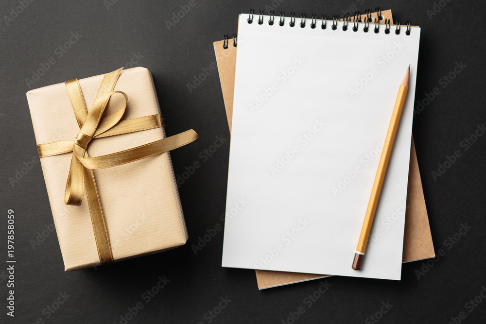 school notebook with gifts on black background, gift boxes with spiral notepad school notebook with gifts on black background, gift boxes with spiral notepad