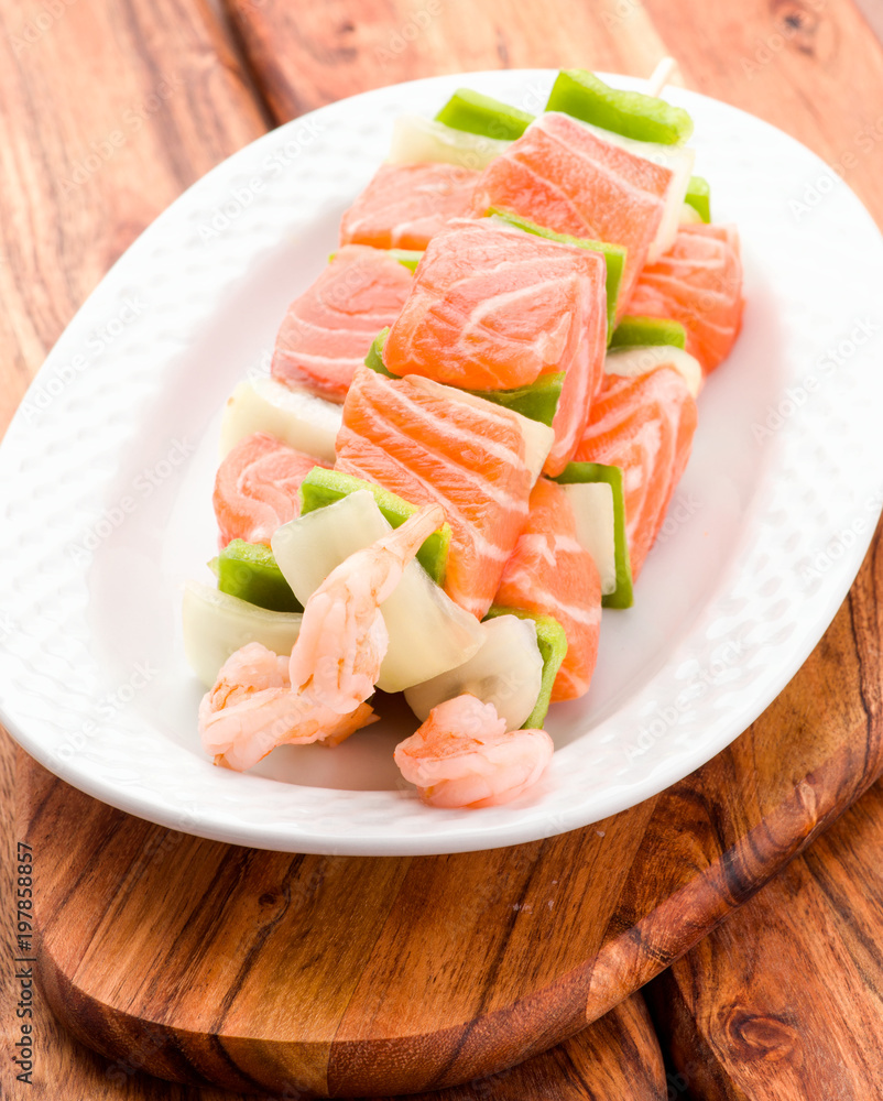 raw skewer of salmon prawns and vegetables raw skewer of salmon prawns and vegetables