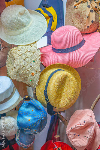 Multi-colored women's hats in the shop window fashion