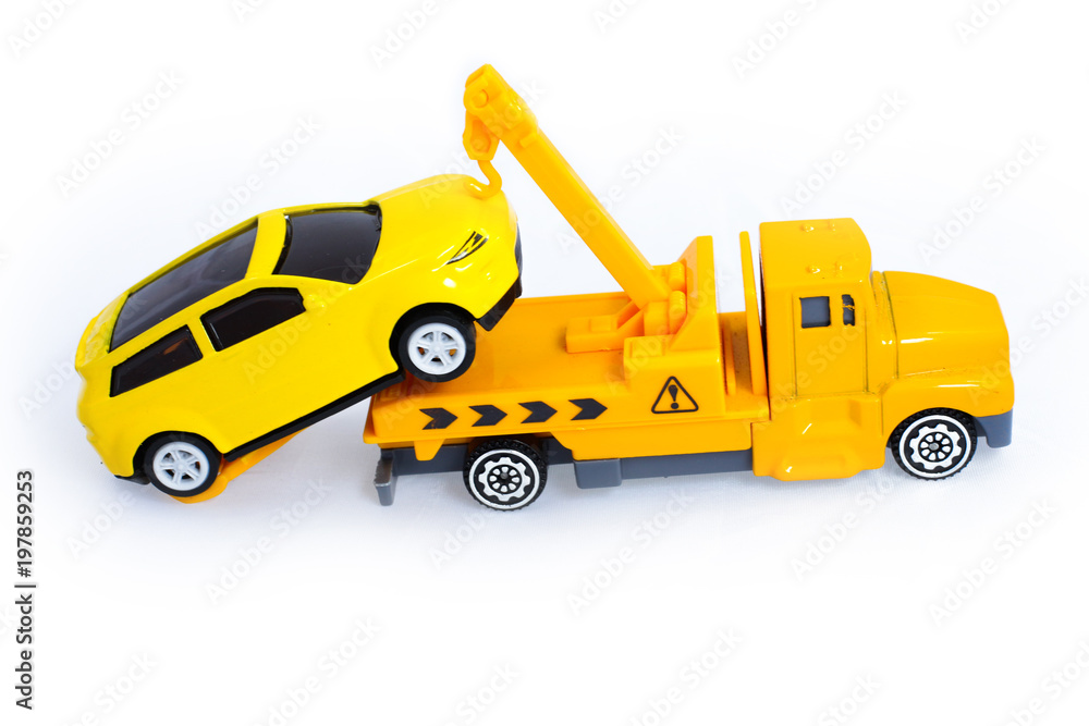 Toy trucks for kids towing vehicle yellow isolate on white background Toy trucks for kids towing vehicle yellow isolate on white background