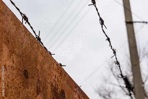 Barbed wire against the sky on cloudy day