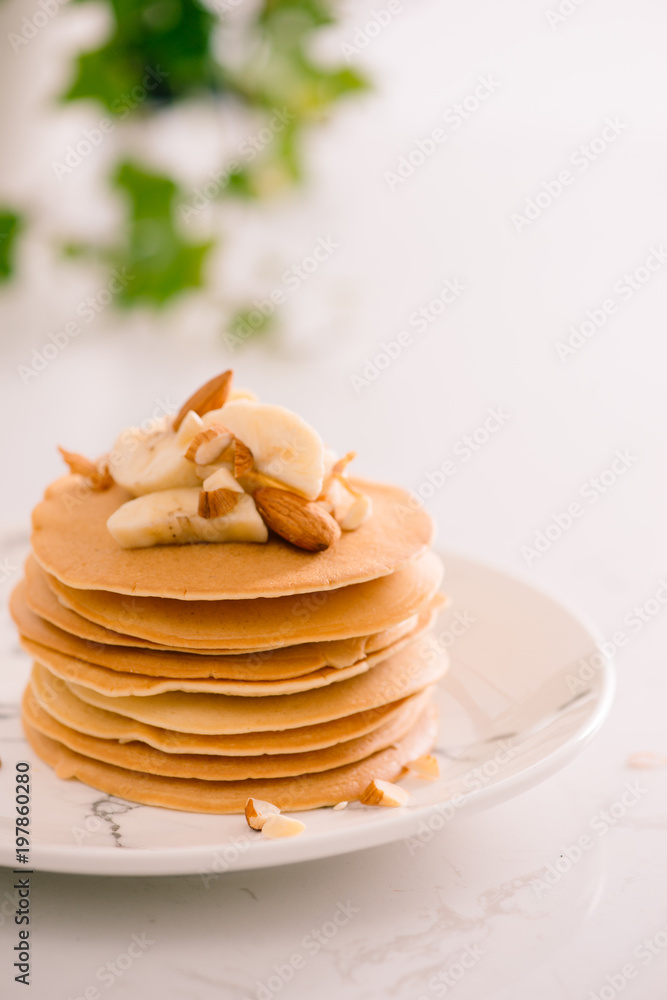 Banana cashew pancakes with bananas and caramel sauce.