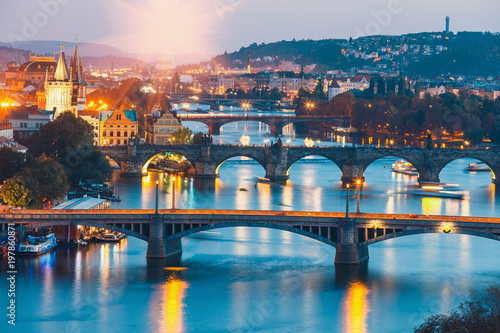 Fotografie bridges with historic Charles Bridge and Vltava river at night in Prague, Czech