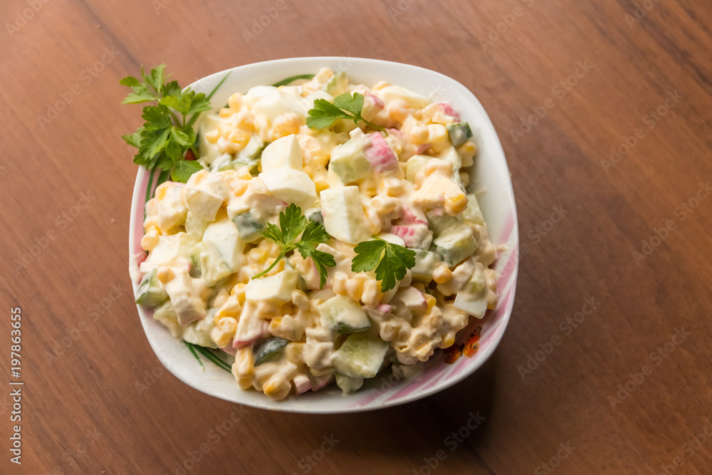 Salad with crab sticks, sweet corn, cucumber, eggs and mayonnaise Salad with crab sticks, sweet corn, cucumber, eggs and mayonnaise