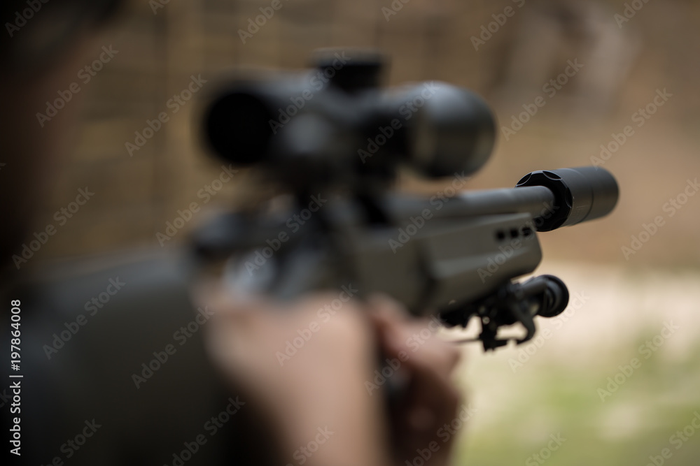 Sniper shooting rifle by looking through a scope. Sniper shooting rifle by looking through a scope.
