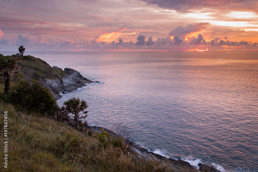 Sunset view at Promthep cape with calm water in an ocean at Phuket, Thailand