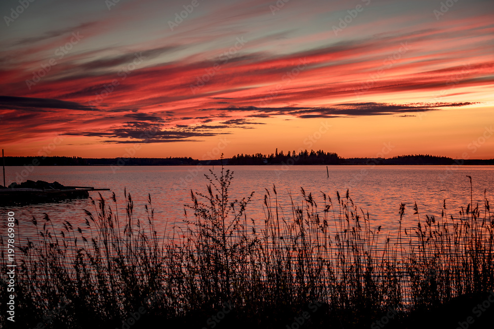 Crimson sunset on the background of the Gulf of Bothnia
