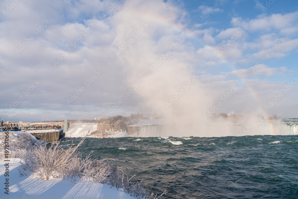 Fototapeta premium Niagara Falls in Winter with rainbow