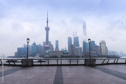 Photography Shanghai high rises office and towers of the Business district skyline at mist behind a pollution haze, across Huangpu river, Shanghai, China