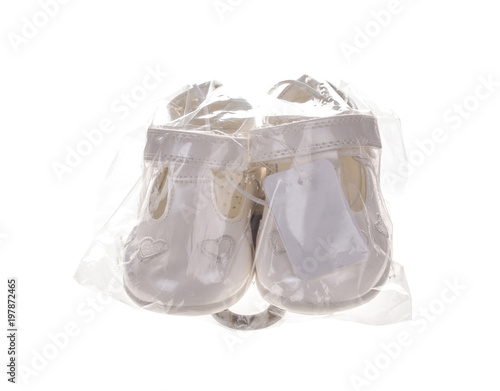 Childrens shoes in a plastic bag.