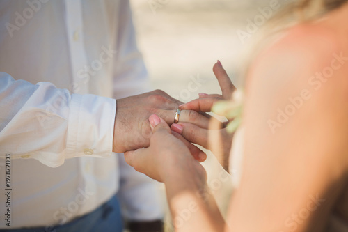 bride wears a ring on the groom s finger