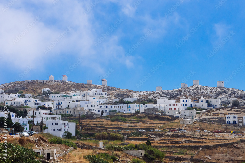 Fototapeta premium Amorgos, Greece-August 2,2017.A panoramic view of the Chora of Amorgos, with the windmills on the right