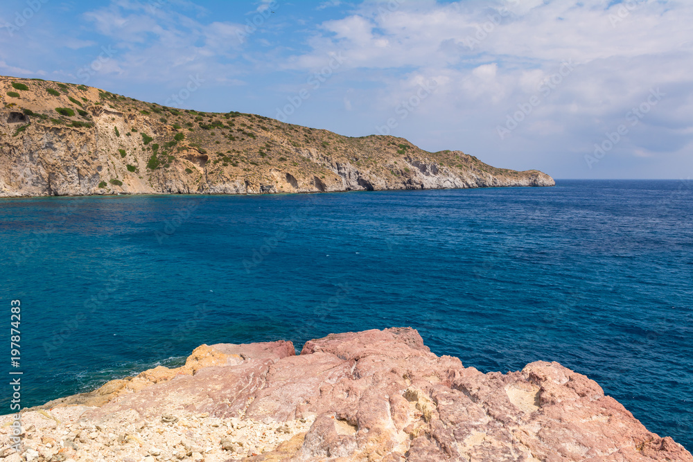 Rocks and blue sea water in Firopotamos Bay on Milos, Cyclades Islands, Greece.