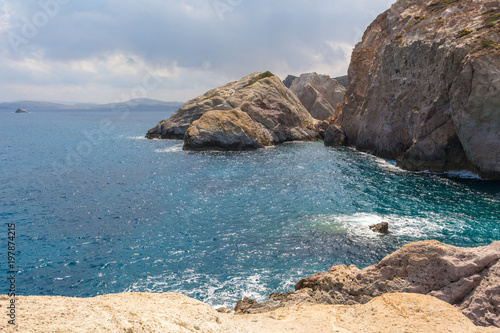 Rocks and emerald sea water in Firopotamos Bay on Milos  Cyclades Islands  Greece.