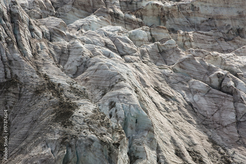 Aerial view of show and ice of Kashkatash Glacier on the west Caucasian mountains in Russia.