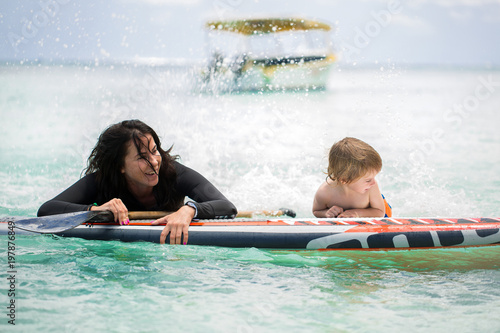 Photography Mom and son have surfing in the ocean on the blackboard