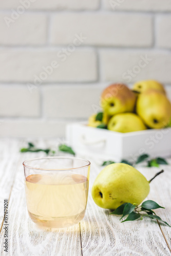 Glass of pear compote on light wooden background. Selective focus, space for text. 