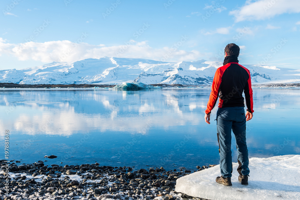 adventurer resting at jokulsarlon glacier, iceland adventurer resting at jokulsarlon glacier, iceland
