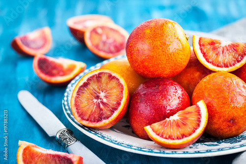 Sliced and whole fresh ripe juicy sicilian blood oranges photo