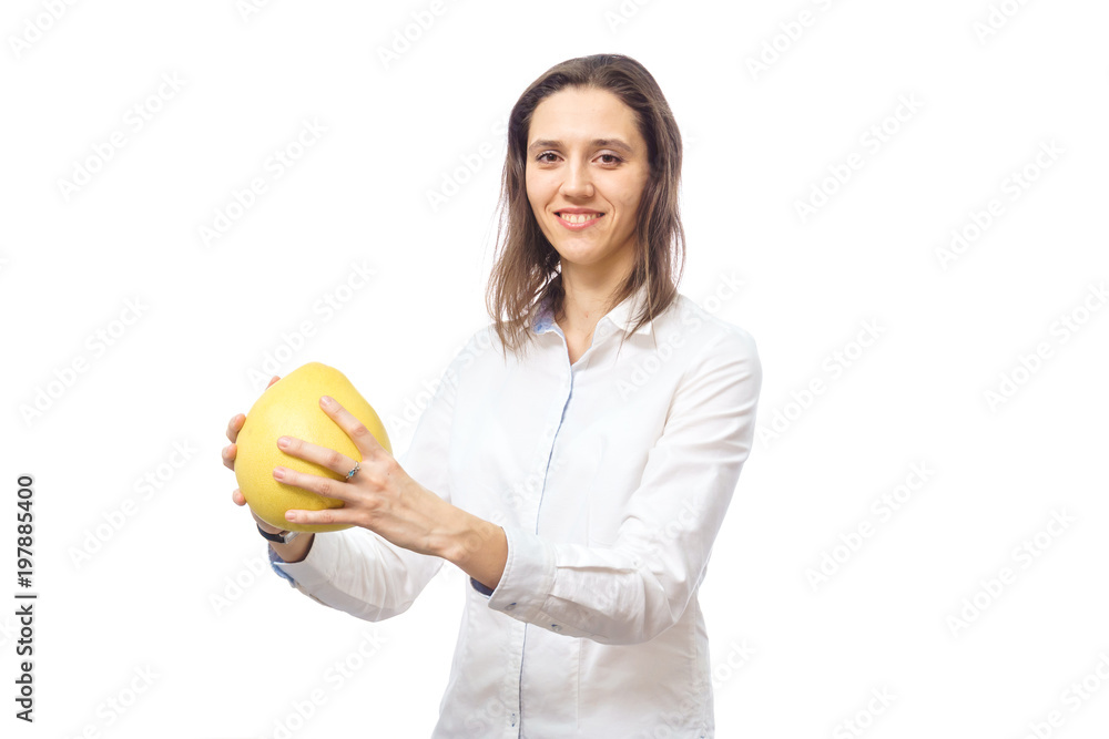 Slender girl in a swimsuit with fruit pamelo on a white background. Healthy eating, beautiful figure Slender girl in a swimsuit with fruit pamelo on a white background. Healthy eating, beautiful figure