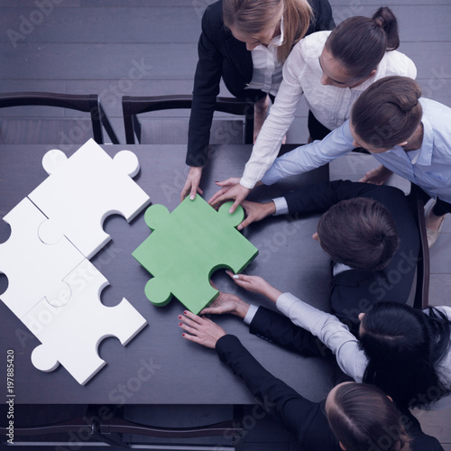 Business people assembling puzzle
