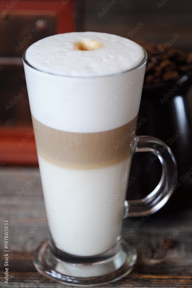Delicious fresh latte coffee on wooden table Delicious fresh latte coffee on wooden table