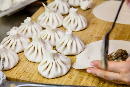 The chef prepares traditional Georgian khinkali.