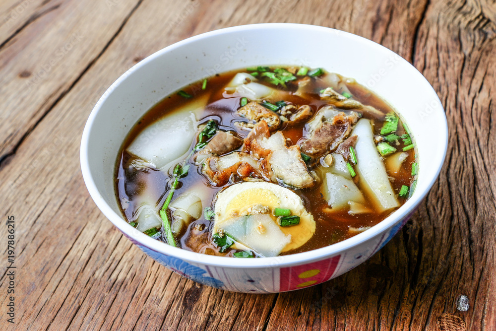 Rice Noodle Soup with pork spare ribs on wooden background Rice Noodle Soup with pork spare ribs on wooden background