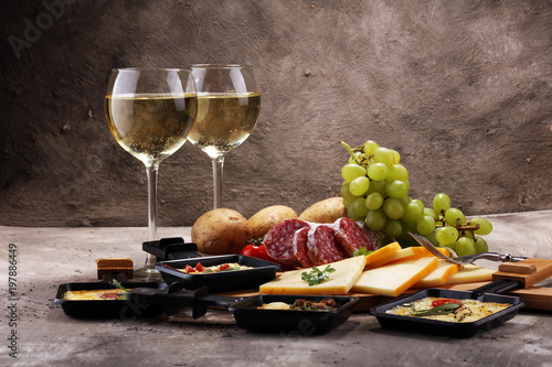 Canvas Print Delicious traditional Swiss melted raclette cheese on diced boiled or baked potato
