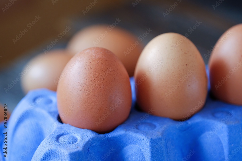 Chicken eggs in the purple package on the table Chicken eggs in the purple package on the table
