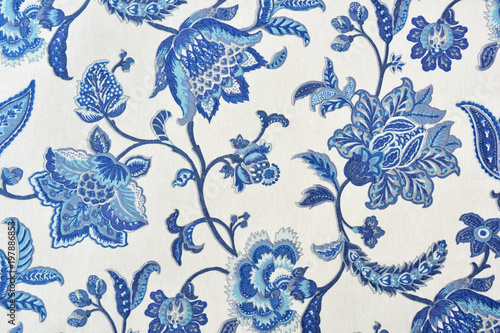 Blue ornate floral pattern on white cotton tablecloth.