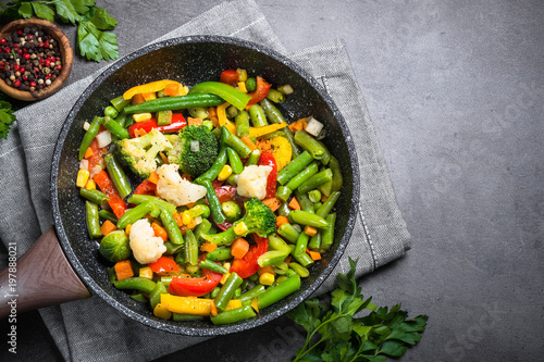 Stir fry vegetables in the wok.