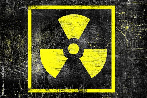 Nuclear radiation sign on old grungy wall. Symbol of radiation contamination. Monochrome black yellow illustration