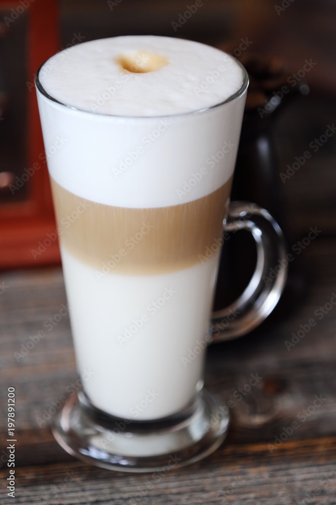 Delicious fresh latte coffee on wooden table Delicious fresh latte coffee on wooden table