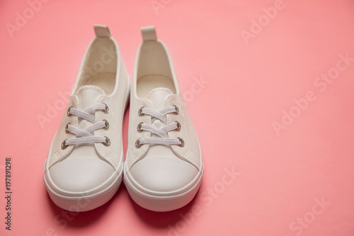 Overhead Shot Of White female Sneakers On Pastel Pink Background