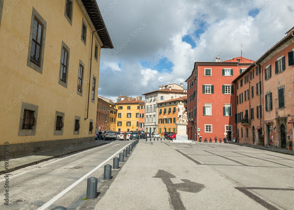 PISA, ITALY - MARCH 8, 2018: Piazza Carrara with colorful buildings. Pisa attracts 3 million tourists annually