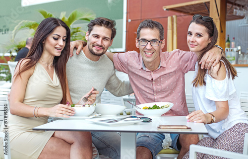 Portrait of cheerful freinds in the summer restaurant