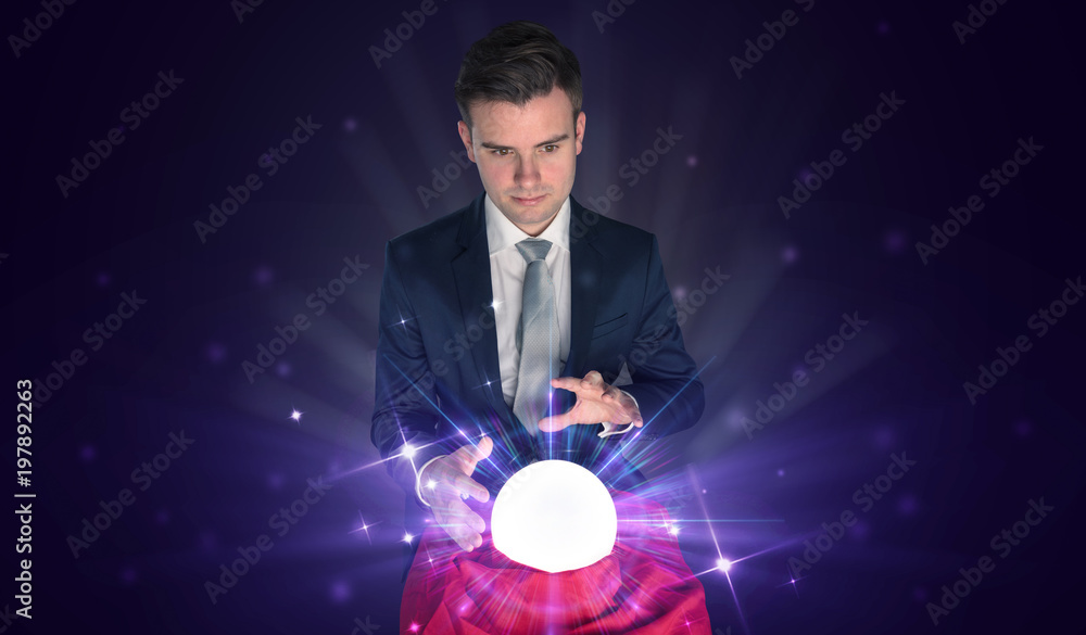 Fototapeta premium Young businessman sitting with crystal ball in action