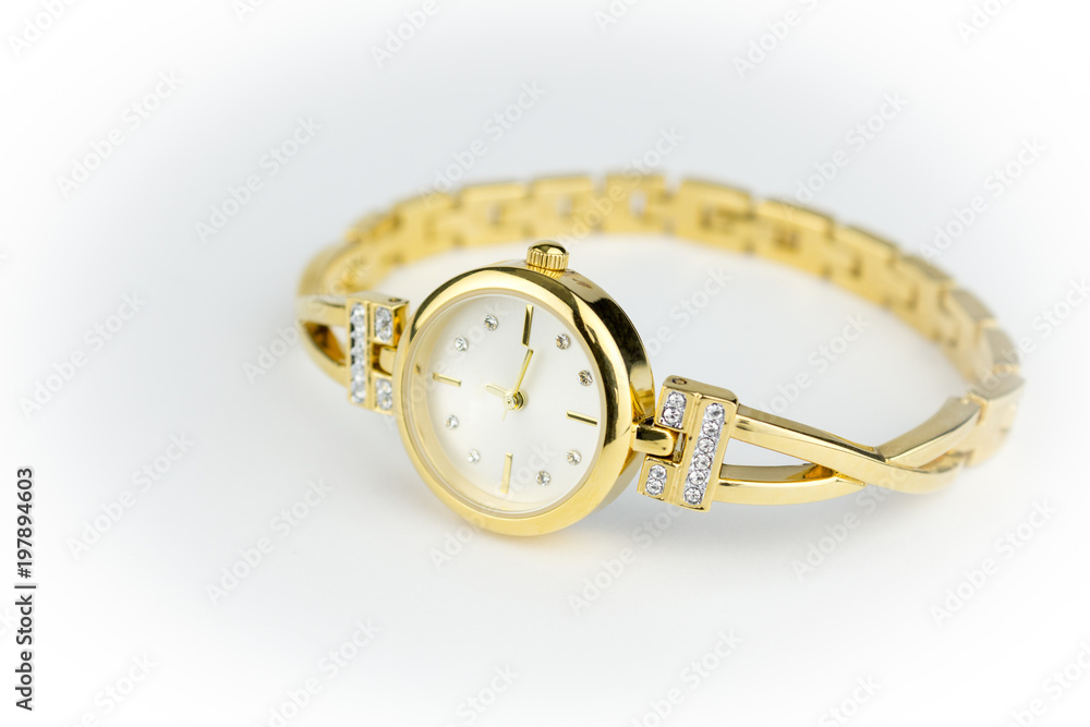 Ladies gold watch with diamonds isolated on white background with narrow depth of field Ladies gold watch with diamonds isolated on white background with narrow depth of field