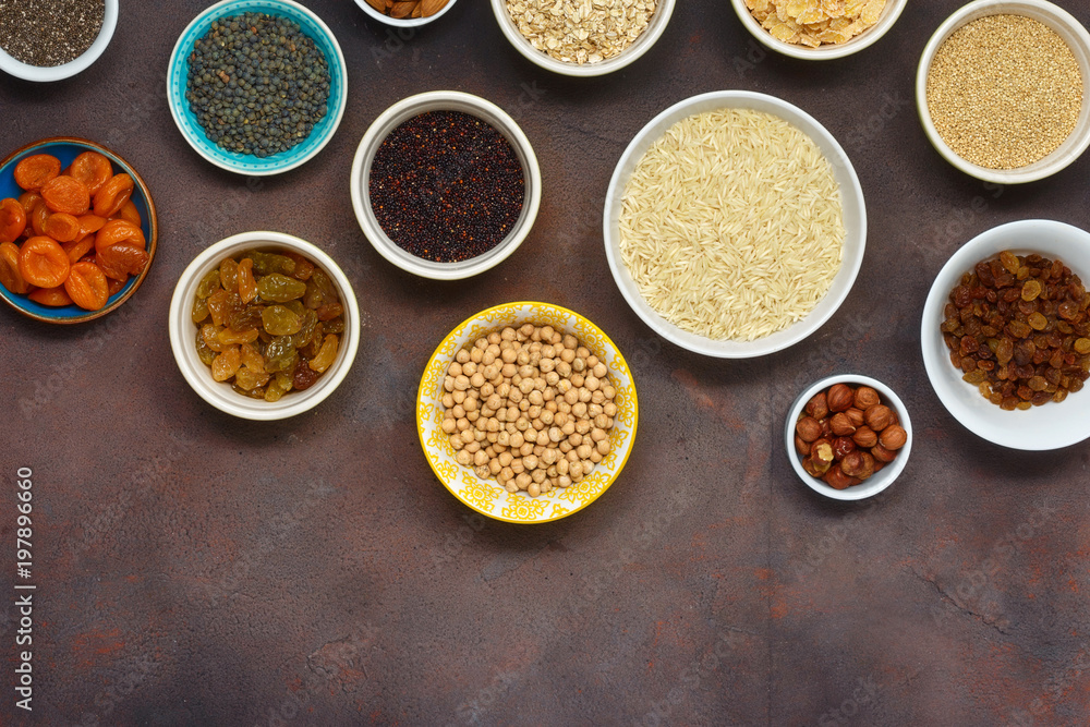 Flat lay top view set vegetarian healthy food - different superfood, seeds and cereal on dark background with copy space. Clean eating