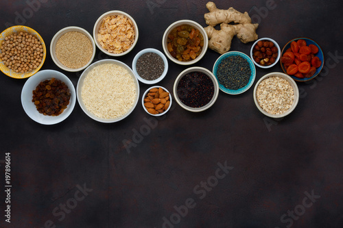 Top view different superfood, seeds and cereal on dark background with copy space. Flat lay set vegetarian healthy Clean food