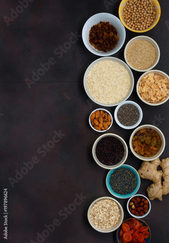 Set vegetarian healthy food - different superfood, seeds and cereal on dark background with copy space, top view. Flat lay. Clean eating concept