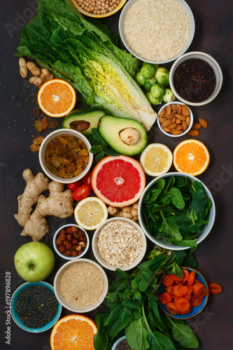 Top view set clean eating. Vegetarian healthy food - different vegetables and fruits  superfood  seeds  cereal  leaf vegetable on dark background. Flat lay