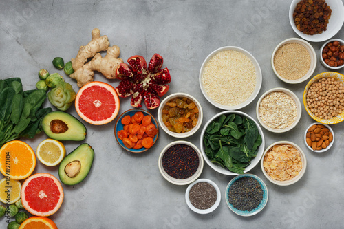 Clean eating concept. Set healthy food - different vegetables and fruits, superfood, seeds, cereal, leaf vegetable on light background, top view. Flat lay