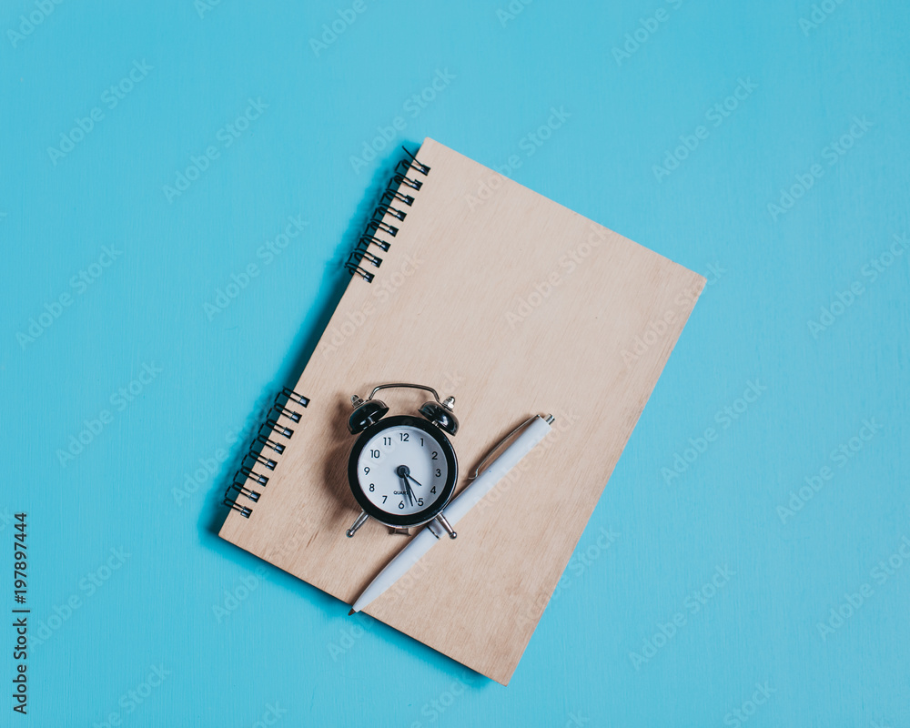 Spiral book with pencil on blue background stock photo Spiral book with pencil on blue background stock photo